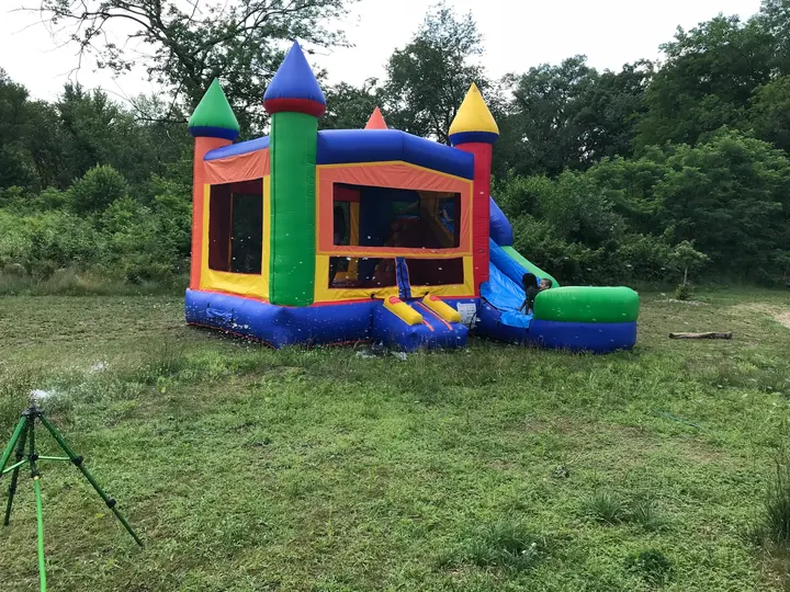 A bounce house on the grass.