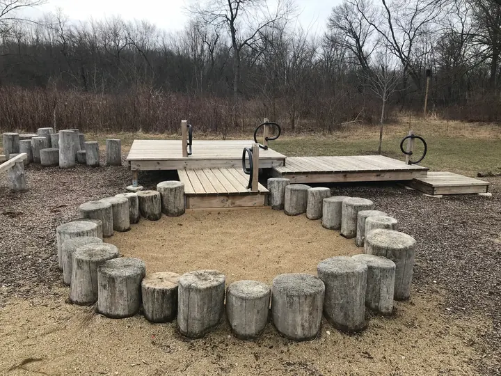 A ring of stump seats around a fire pit at Camp Shabbona Woods.